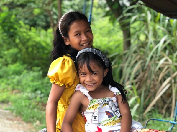 Two sisters in dresses in Cambodia