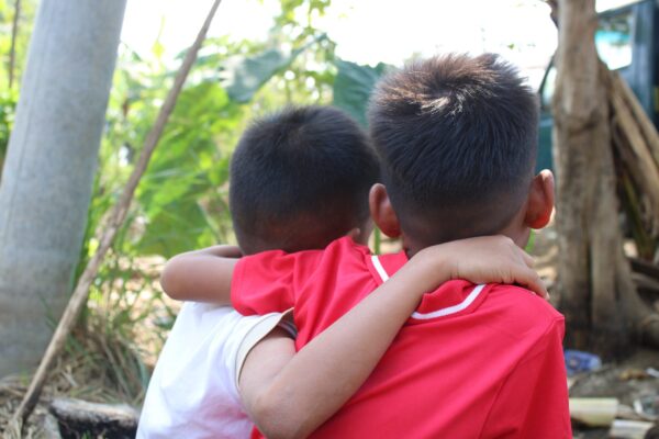 Brothers with arms around each other in foster care program to protect from Child Trafficking