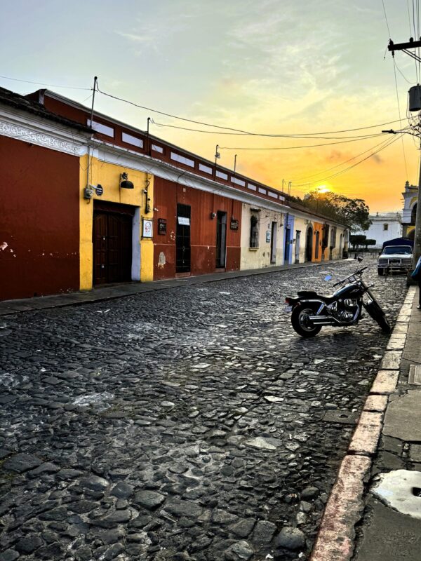 Antigua, Guatemala street at sunrise with a motorcycle