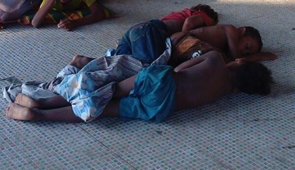 Street children sleeping on the ground