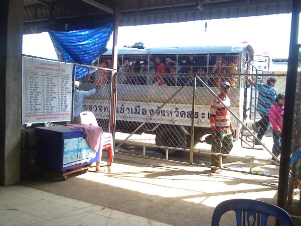 Police truck filled with people at the Cambodian border