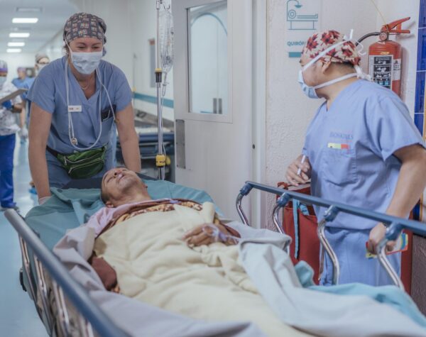 Man being taken to operating room by two nurses