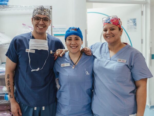 Three volunteers in scrubs in a hospital in Guatemala