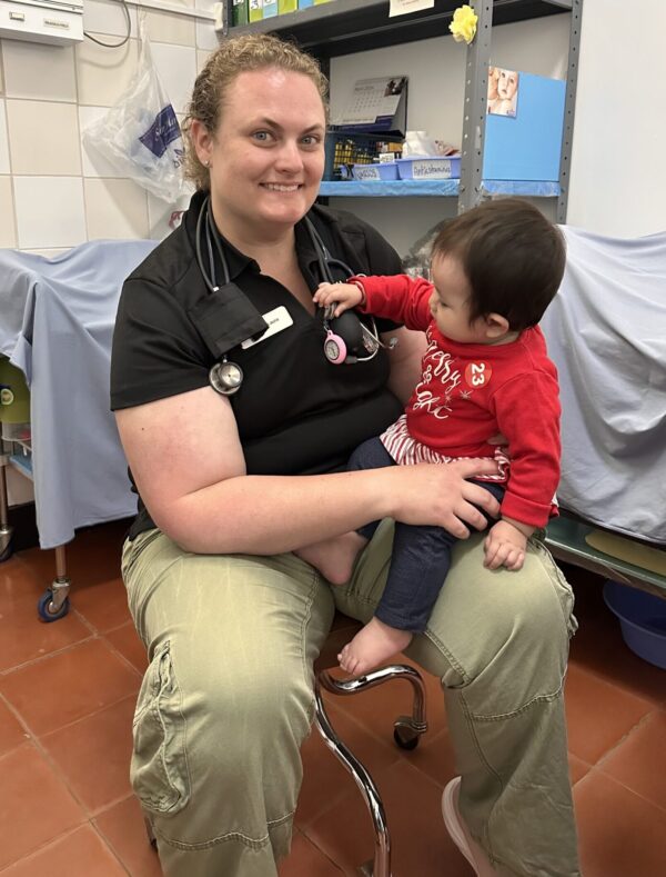 PACU nurse holds baby on her lap