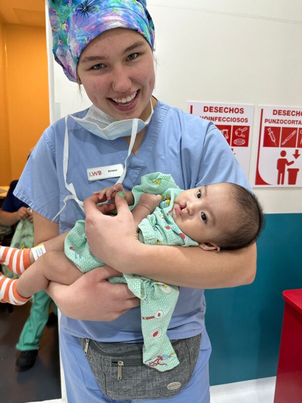 Nurse holds a baby with cleft lip